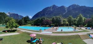 a group of people in a park with mountains in the background at Haus Dahuam in Sautens