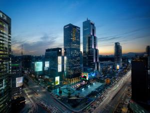 a city skyline at night with traffic on a busy street at Park Hyatt Seoul in Seoul
