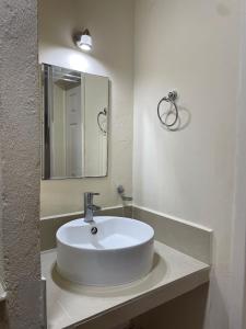 a white sink in a bathroom with a mirror at Hotel Dos Mundos, Isla Cozumel in Cozumel +27 photos