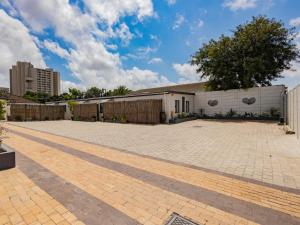a brick parking lot in front of a building at La Bella Vida Self Catering Apartments in Bellville