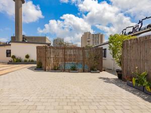 a wooden gate in a courtyard with a fence at La Bella Vida Self Catering Apartments in Bellville