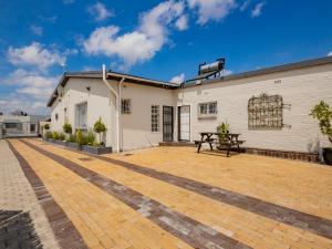an outdoor patio with a table and a building at La Bella Vida Self Catering Apartments in Bellville +9 photos
