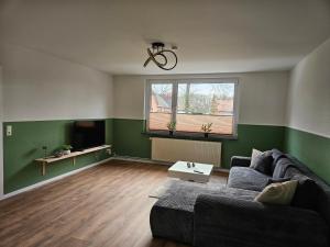 a living room with a couch and a window at Fewo Kirch Jesar in Kirch Jesar