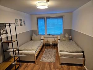 a room with two beds and a window at Fewo Kirch Jesar in Kirch Jesar