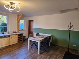 a kitchen with a table and chairs in a room at Fewo Kirch Jesar in Kirch Jesar