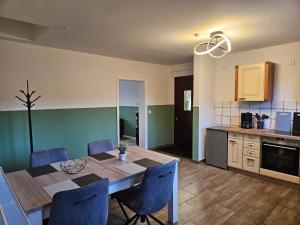 a kitchen and dining room with a table and chairs at Fewo Kirch Jesar in Kirch Jesar +11 photos