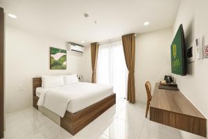 a hotel room with a bed and a window at Soi by La Doma Express in Ho Chi Minh City