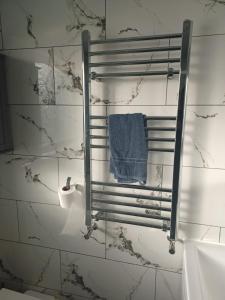 a mirror in a bathroom with a blue towel at Byron View House in Luton +23 photos