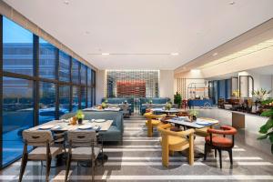 a rendering of a restaurant with tables and chairs at Novotel Yangquan High-Tech Zone in Yangquan