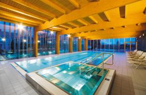 a large swimming pool in a building at Park Hotel Tartuf in Beladice
