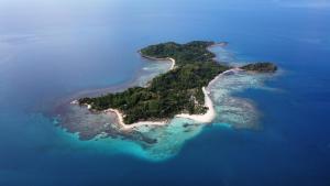 a small island in the ocean with a beach at Darocotan Shipwreck Camping in El Nido