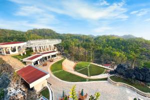 an aerial view of a building with a garden at Stone Valley Resort & Beach in Tepus +6 photos