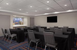 a conference room with black tables and chairs and a flat screen tv at Hampton Inn & Suites Cleveland-Mentor in Mentor