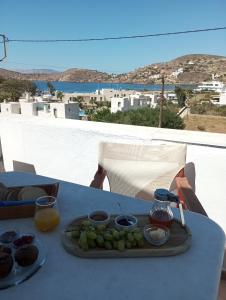 a tray of food on top of a table with juice at Hotel Faros in Ios Chora