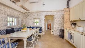 a kitchen and dining room with a table and chairs at Villa Mendula -Orebic by Villas Guide in Orebić +21 photos