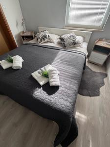 a bedroom with a bed with two towels on it at Apartman Dani - Sutivan in Sutivan