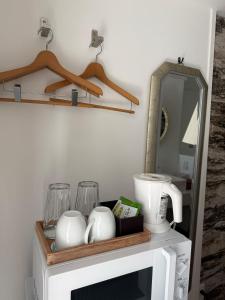 a shelf on top of a microwave with a mirror at WITH SEA Nakama in Onna
