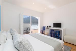 a bedroom with a bed and a desk with a television at Villa Mykonos in Cape Town +26 photos