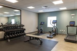 a gym with treadmills and exercise equipment in a room at Hampton Inn Orange City in Orange City