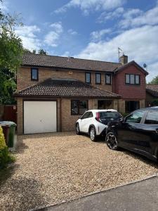 two cars parked in front of a house at Buckingham Osprey in Buckingham