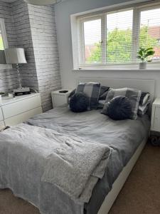 a bedroom with a bed with pillows and a window at Buckingham Osprey in Buckingham