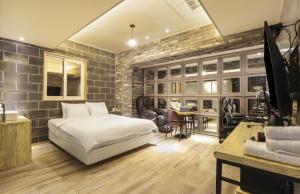 a bedroom with a white bed and a brick wall at 대구 더스테이낭만 태전점 in Daegu +31 photos