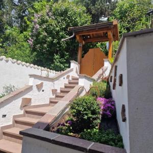 a set of stairs in a garden with flowers at Appartamento Genzianella Monolocale in Cavalese +6 photos