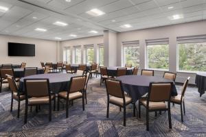a conference room with tables and chairs and a flat screen tv at Hampton Inn & Suites Chicago-Downtown in Chicago +47 photos