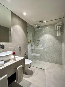 a bathroom with a shower and a toilet and a sink at Bookmark Resorts, Manali in Manāli +38 photos