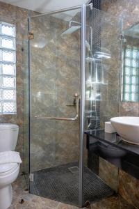 a bathroom with a shower with a toilet and a sink at Sky Charm Hanoi Hotel and Spa in Hanoi +96 photos