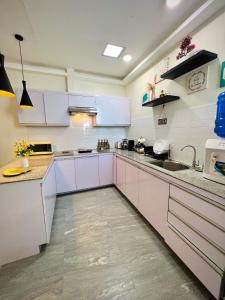 a kitchen with white cabinets and a sink at Serenity Stay in General Santos +7 photos