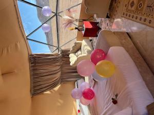 a room with balloons hanging from a ceiling at Wadi Rum Main Road Visitor Center in Disah