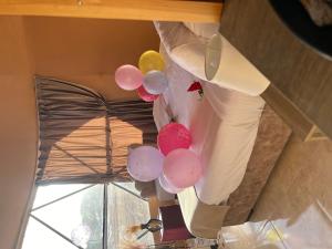 a bunch of balloons hanging from a ceiling at Wadi Rum Main Road Visitor Center in Disah