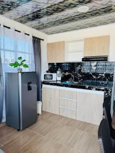 a kitchen with a stainless steel refrigerator in it at Apartamentos el mochilero frente al mar piso 2 apto 3 in Cartagena de Indias