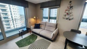 a living room with a christmas tree on the wall at Busan Osiria Residence Losiria in Busan