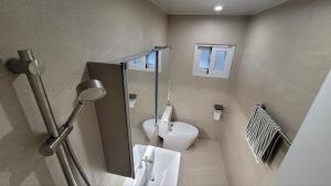 a bathroom with a toilet and a sink at 모던한 스테이 in Samgong