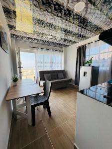 a living room with a table and a couch at Apartamentos el mochilero frente al mar piso 2 apto 3 in Cartagena de Indias +4 photos
