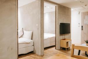 a bedroom with a mirror and a bed and a tv at Meworld Hotel - Daan in Taipei