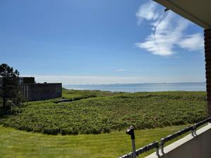 a view of the ocean from a house balcony at Langeneß Whg 15 Strandtraum in Wyk auf Föhr +4 photos