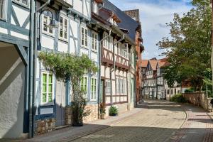 a street in a town with white and blue buildings at Green&Tiny Spot Wolfenbüttel Okeraue - Sleep Space 2 in Wolfenbüttel