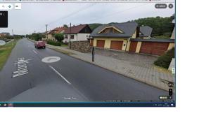 a picture of a car driving down a road with houses at Apartmán Ria in Hriňová