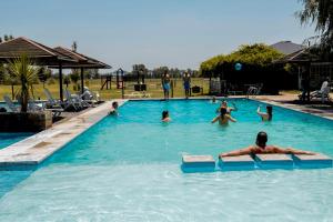 a group of people swimming in a swimming pool at Pampas del Sur - Hotel de Campo - Cañuelas in Cañuelas +25 photos