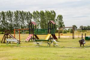 a playground with a slide in a park at Pampas del Sur - Hotel de Campo - Cañuelas in Cañuelas