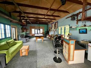a living room with a green couch and a table at Makara Beach Escape in Wellington