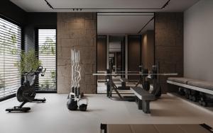 a gym with treadmills and exercise equipment in a room at Villa White Lotus in Selca