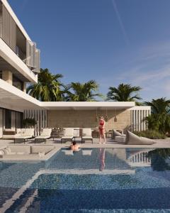 a woman standing in a swimming pool next to a building at Villa White Lotus in Selca