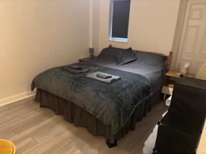 a bedroom with a bed with two towels on it at 4 Castle Walk in Stansted Mountfitchet