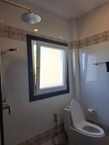 a bathroom with a toilet and a window and a shower at Villa Meerblick in Ban Map Khangkhao +7 photos