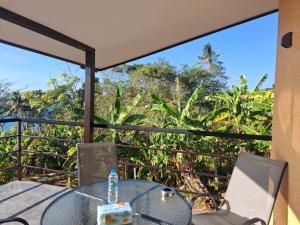 a table and chairs on a balcony with a view at Villa Meerblick in Ban Map Khangkhao