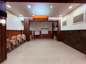 a large room with chairs and a table and a podium at Hotel Alka Residency in Thane